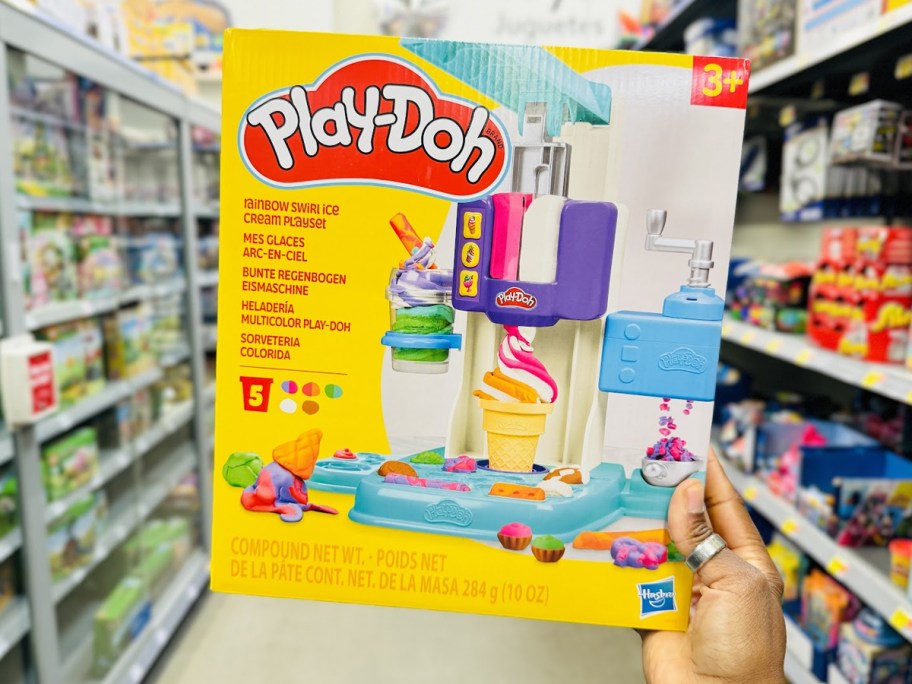 hand holding up Play-Doh Rainbow Swirl Ice Cream Playset box in store