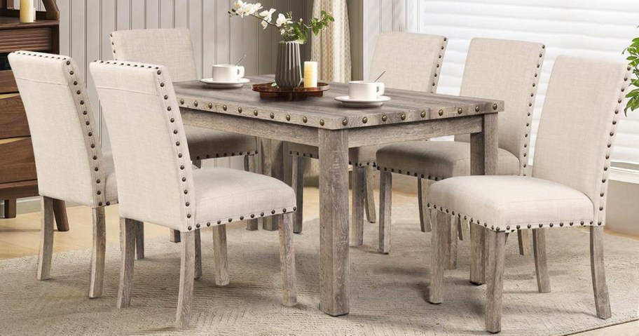 wood dining table with 6 upholstered chairs around it
