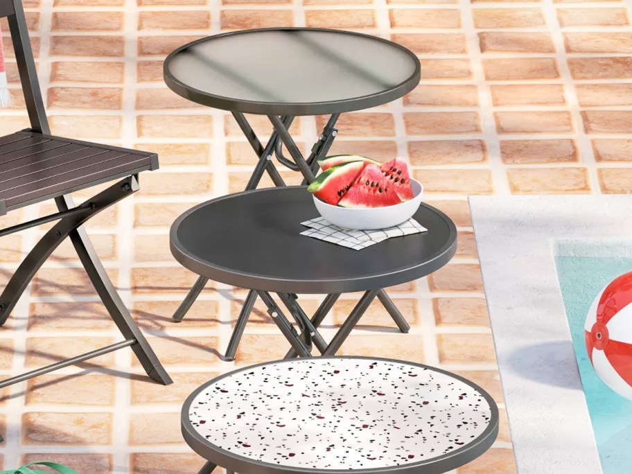 round folding patio tables in a row