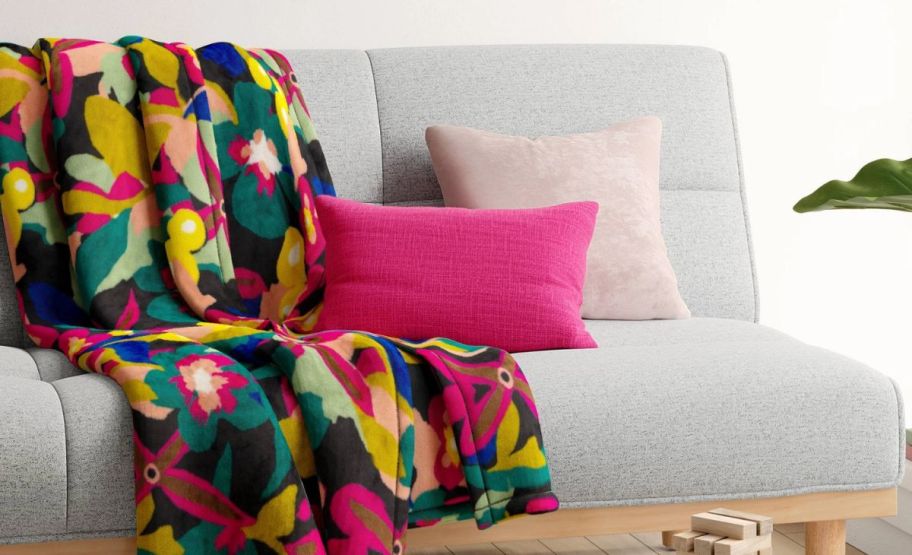 room essential magenta lumbar pillow on a sofa