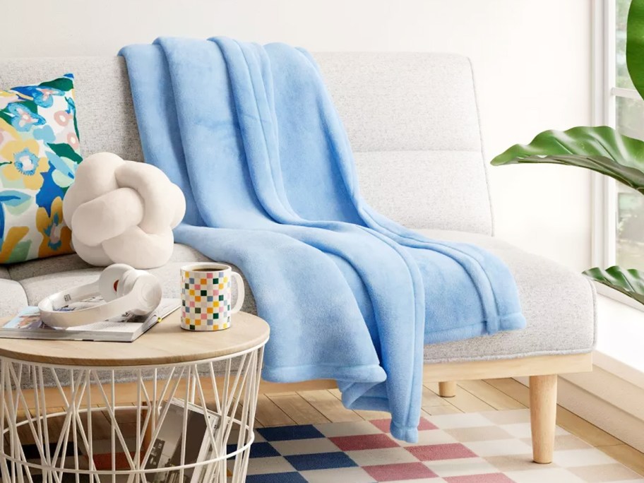 light blue throw blanket draped over couch