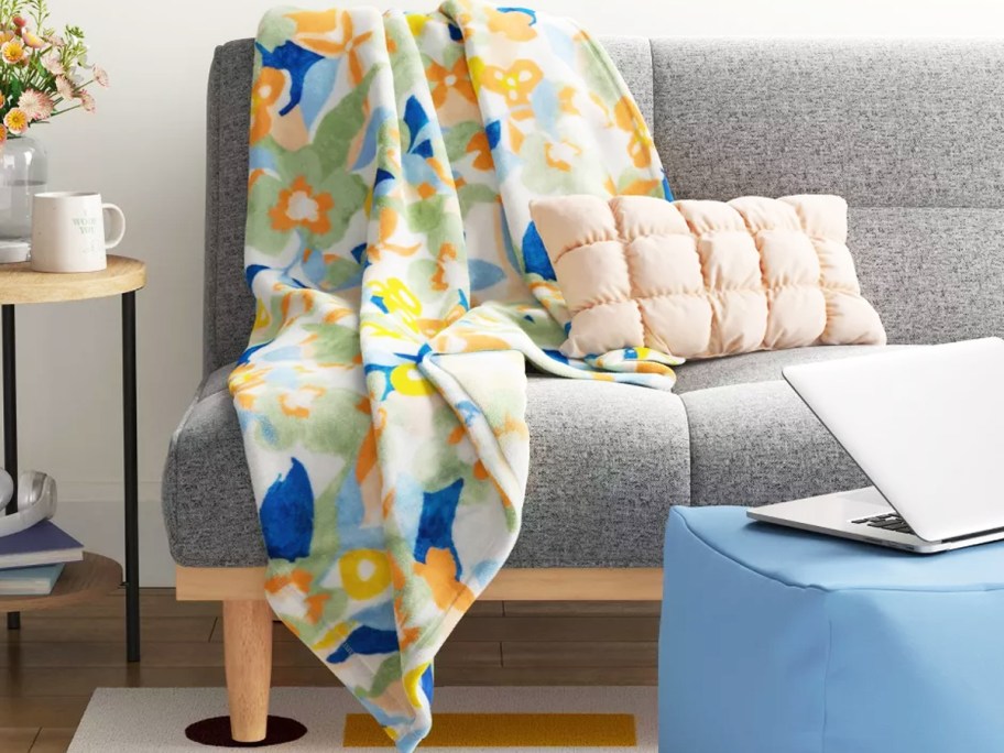floral print throw blanket draped over couch