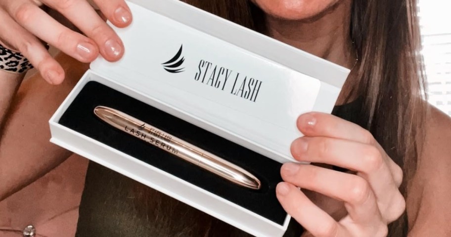 woman holding stacy lash lash serum in box