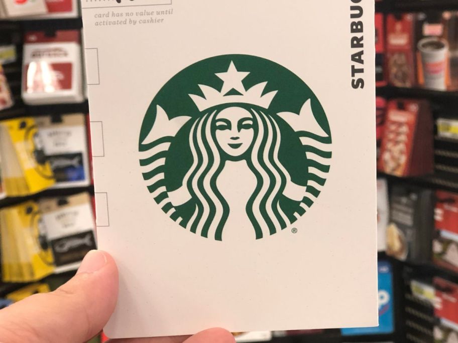 Hand holding up a Starbucks Gift Card