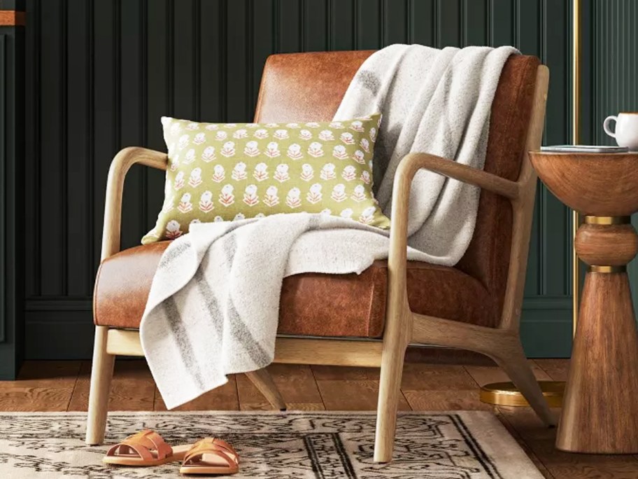 white and grey stripped throw blanket draped over a chair