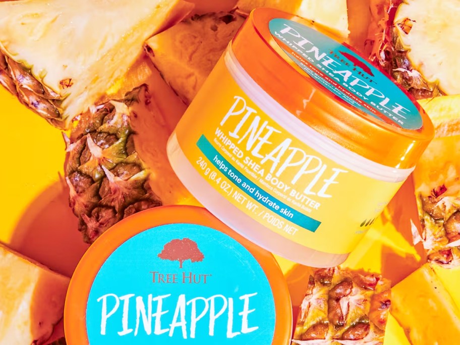 jars of Tree Hut Whipped Shea Body Butter on top of pineapple slices