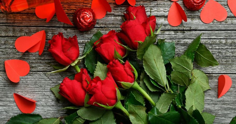 A bouquet of red roses with candies