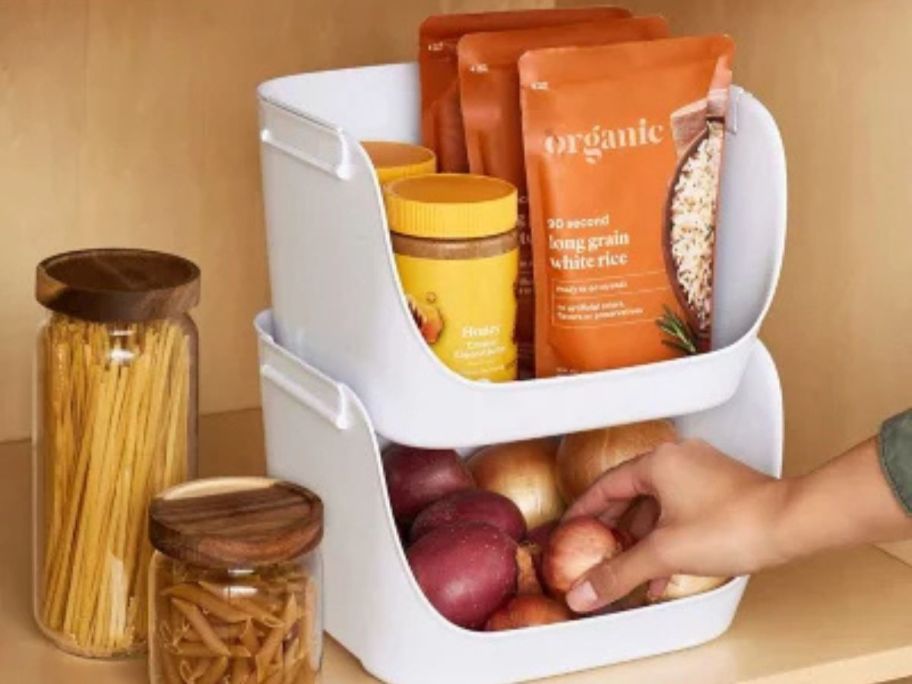 Someone organizing their pantry with a YouCopia ShelfBin