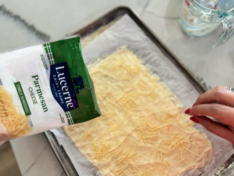 adding parmesan cheese to homemade crackers