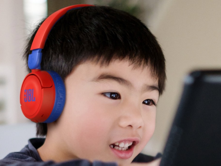 child using JBL headphones in red and blue