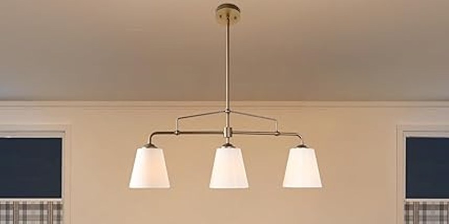 three light chandelier hanging in room