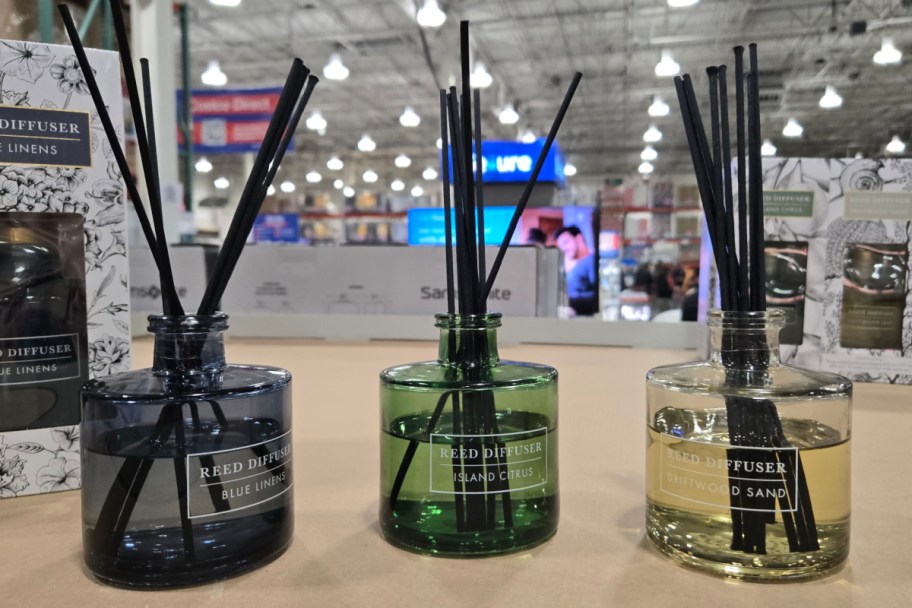 three reed diffusers on shelf in store