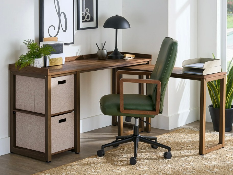 brown l desk with 2 storage cubs and green chair in front 