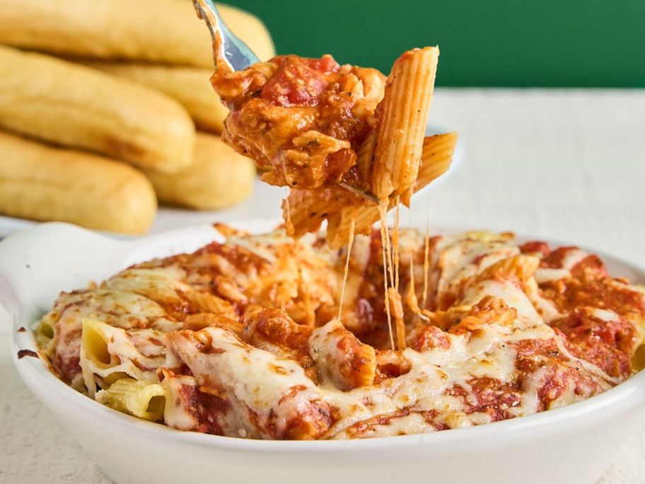 a fork pulling up fazoli's pasta from bowl