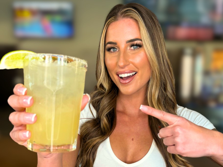 woman holding a margarita on the rocks