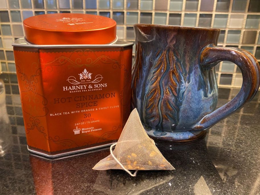 tea tin shown with tea cup and tea bag