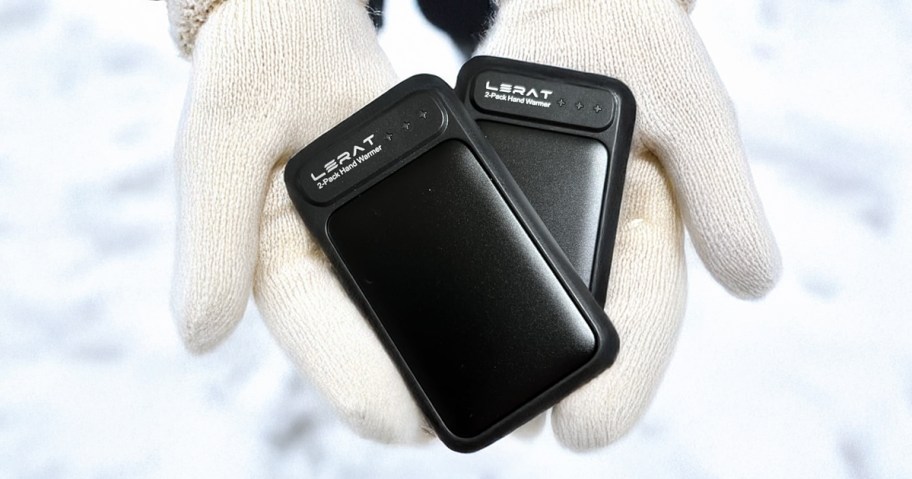 hands with gloves on holding a set of lerat hand warmers