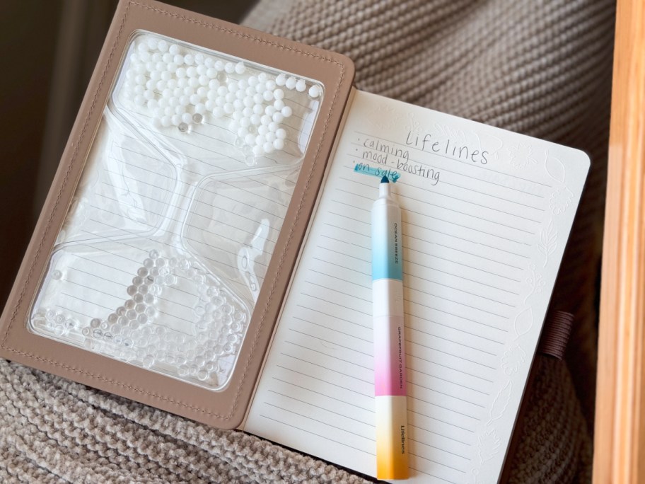 open lifelines journal and pen on a blanket-covered lap