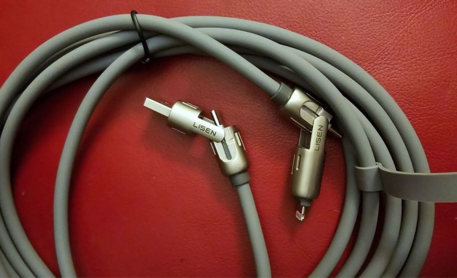 a thick gray charging cable on a red table top