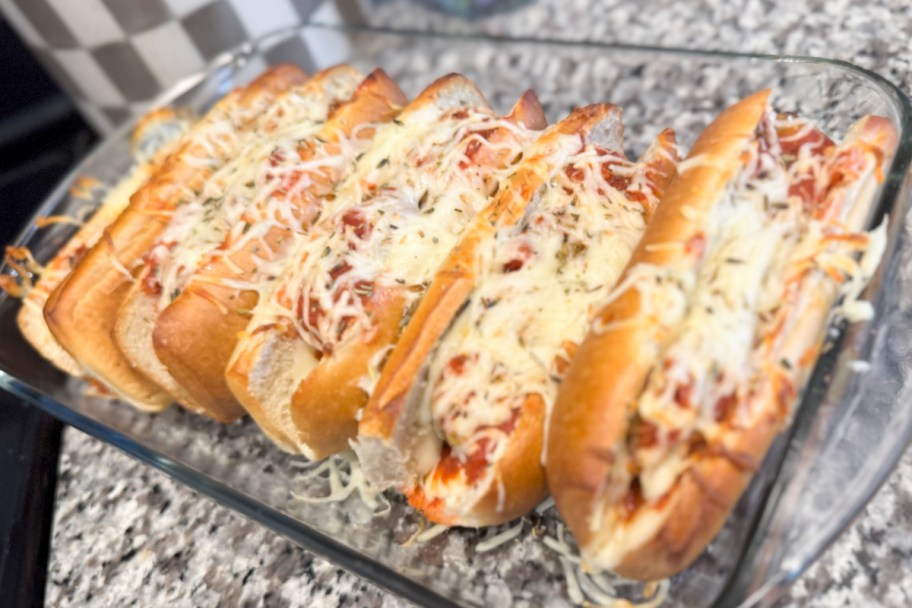 many meatball subs in glass baking dish