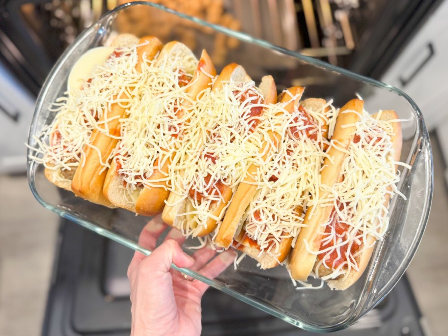 dish with meatball subs going into oven