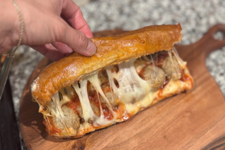 hand grabbing top of meatball sub