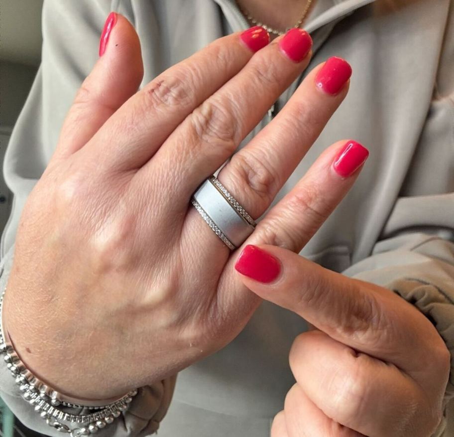 finger pointing to blinged out oura ring on hand