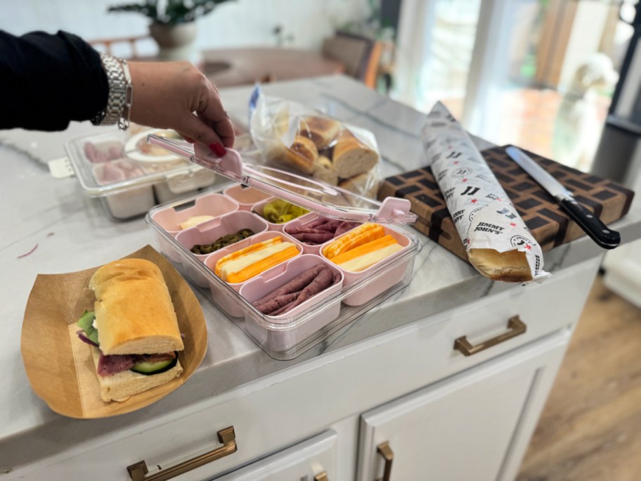 prepping sandwiches on the counter using day old jimmy john's bread