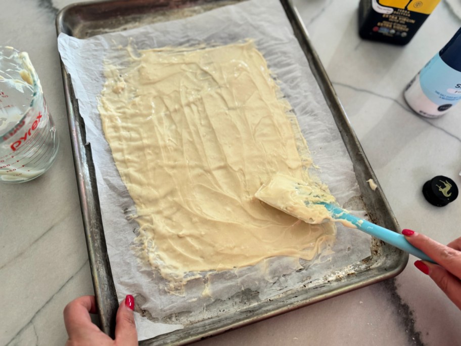 spreading sourdough discard crackers on a sheet pan