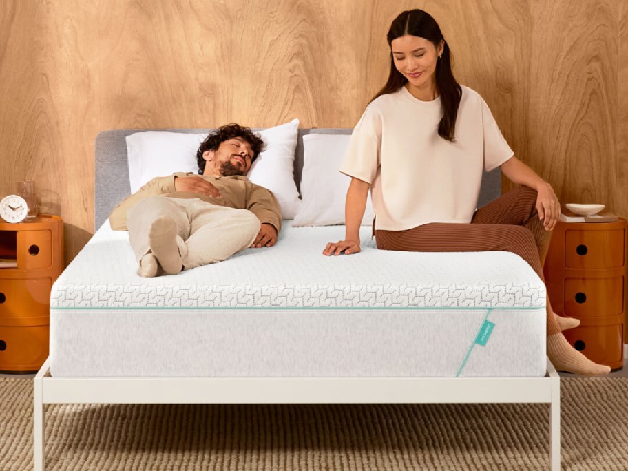 couple sitting on tuft and needle mattress