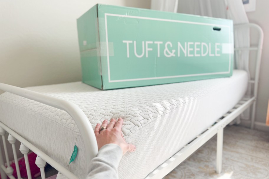 hand holding tuft and needle mattress