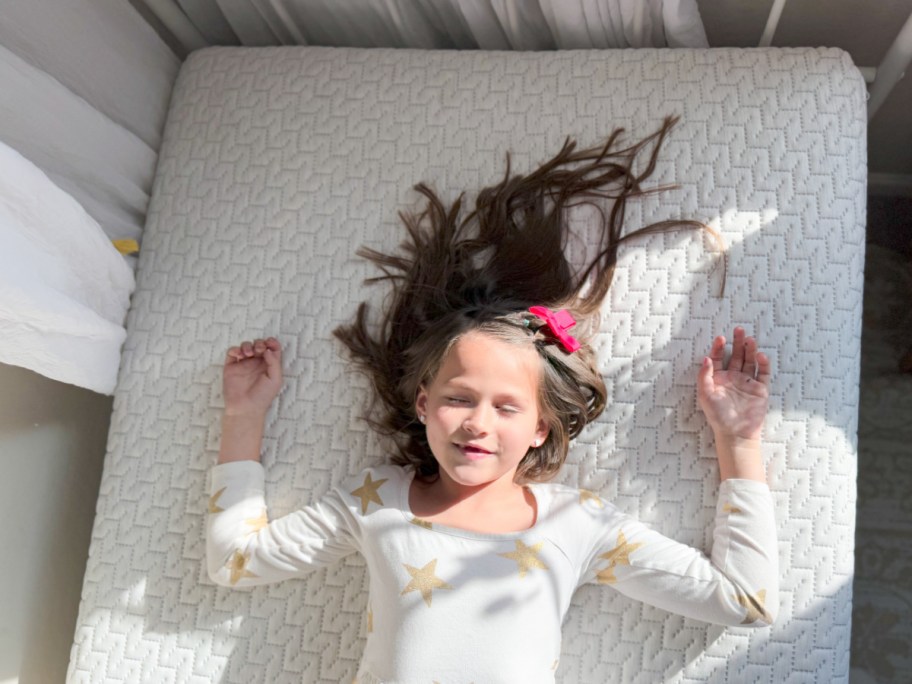 girl laying on tuft and needle mattress