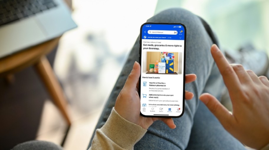 holding a phone showing the Walmart+ app