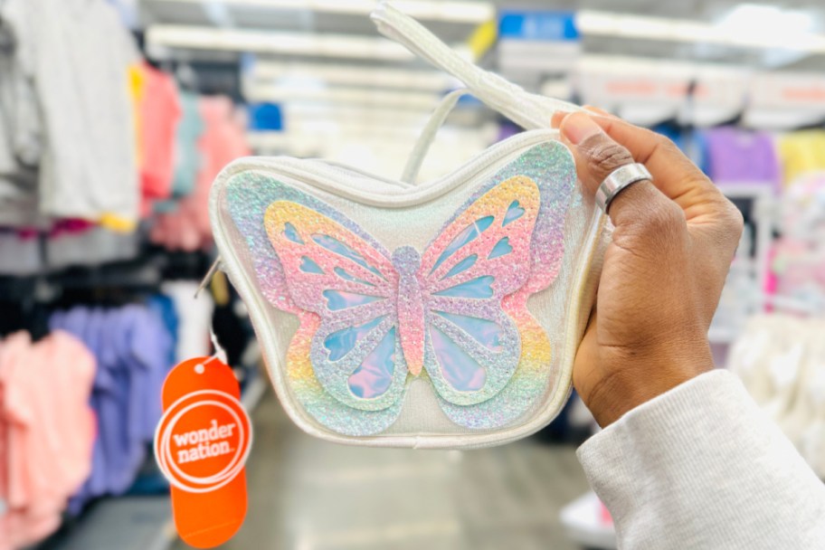 hand holding butterfly purse in store