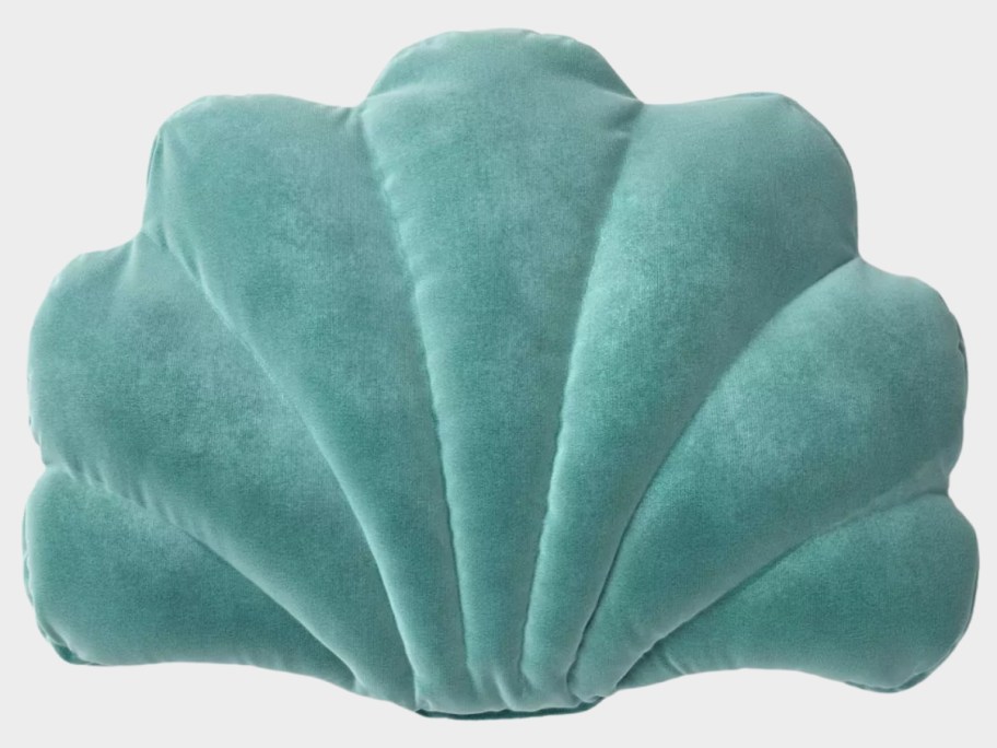 a green seashell shaped velvet throw pillow