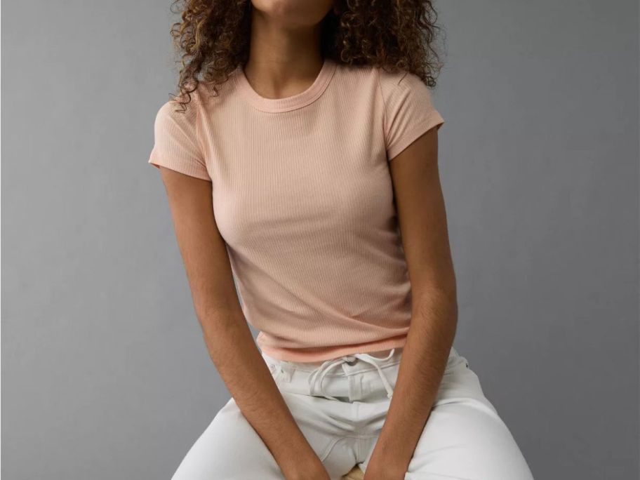 A woman wearing a pink t-shirt