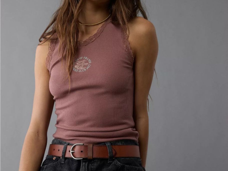 A woman wearing a pink tank