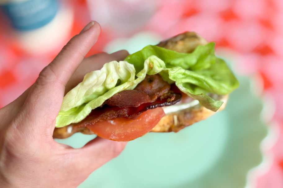 hand holding BLT stuffed chicken breast