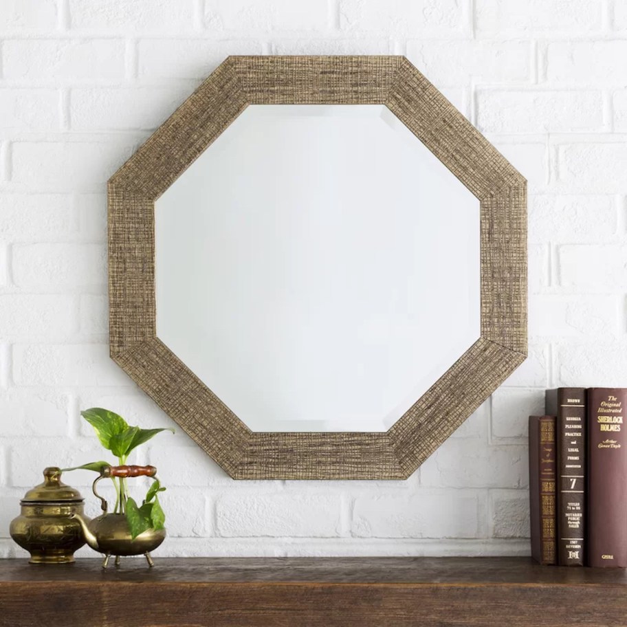 hexagon mirror on white brick wall