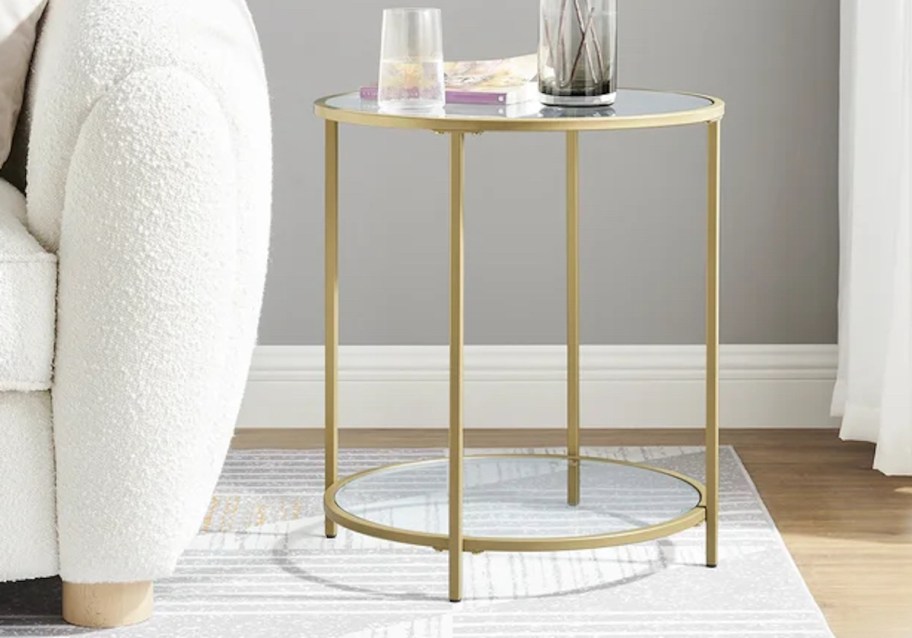 gold and glass end table on rug