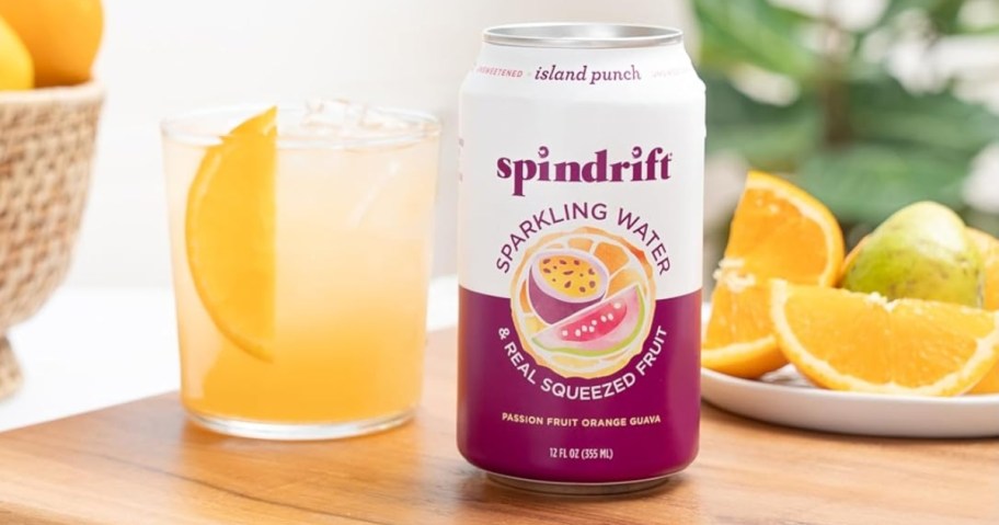 a can of Spindrift Sparkling Water next to glass and lemon slices on a kitchen counter