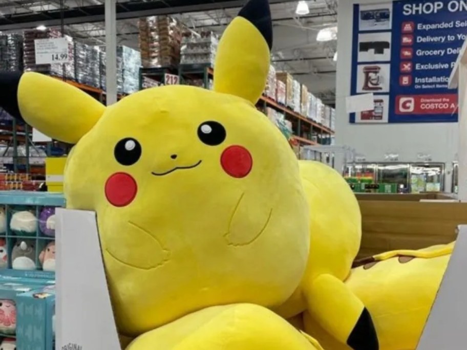 a giant Squishmallows Pikachu plush animal in a bin at Costco