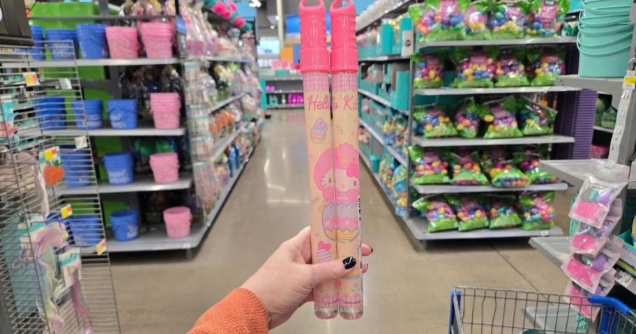 A person holding two Hello Kitty Easter Bubble Wands at Walmart