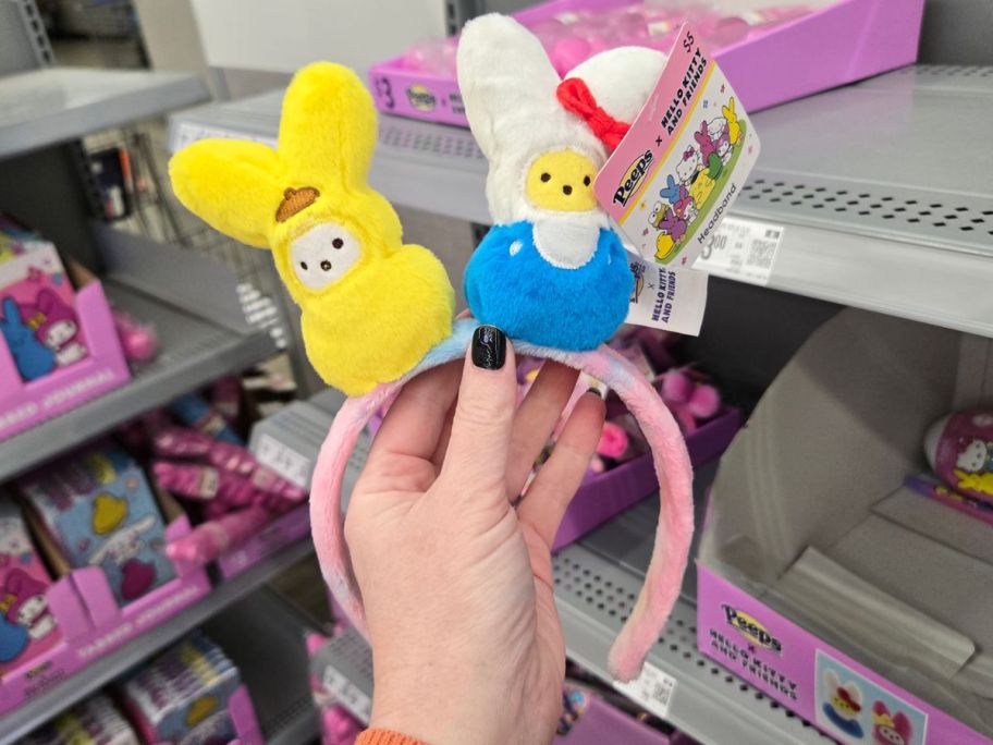 A person holding two Hello Kitty x Peeps Easter Headbands at Walmart