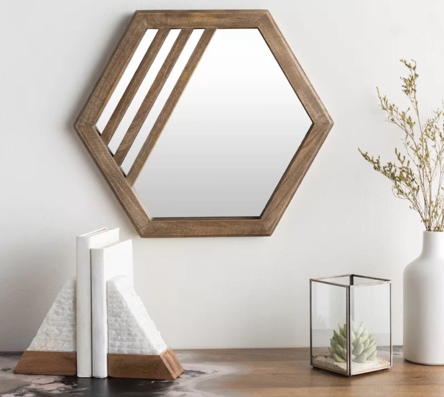 wood hexagon mirror on wall 