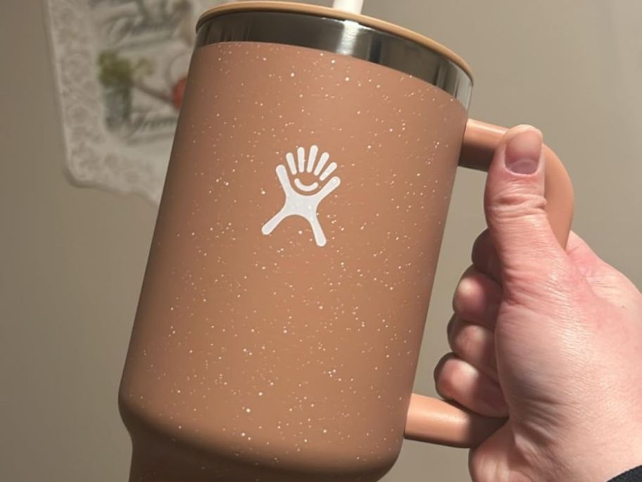 Hand Holding a Sandy Color Hydro Flask Tumbler