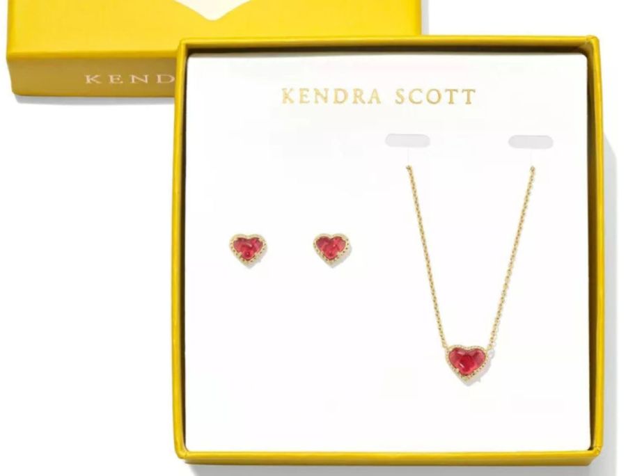 A heart necklace and matching heart earrings in a yellow box. 