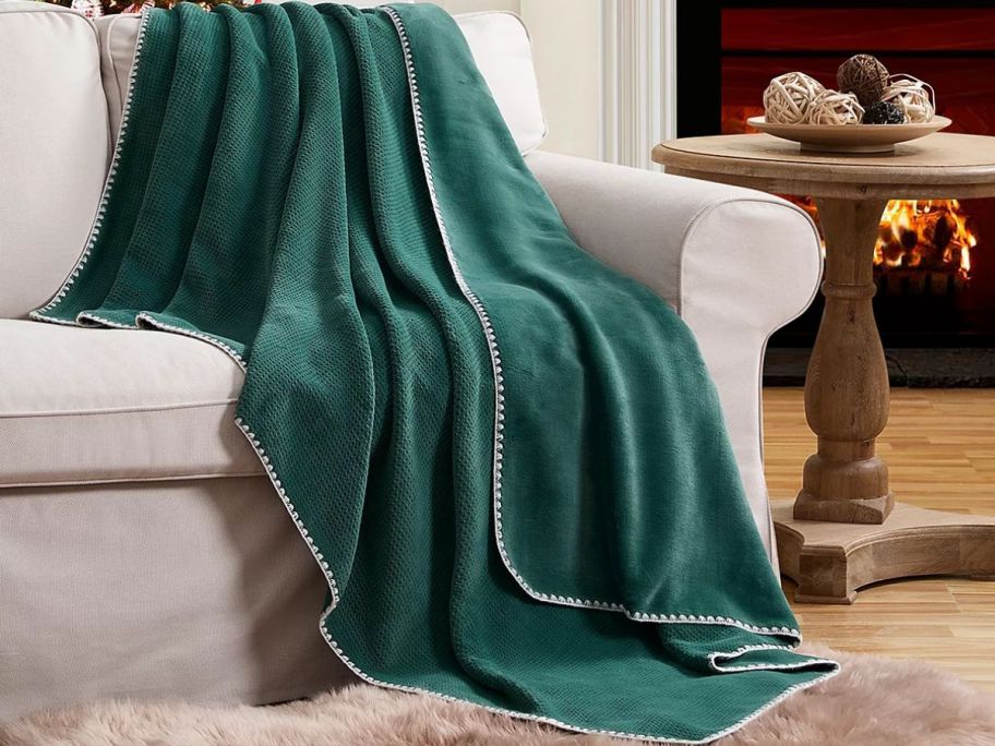 Evergreen Ivy 50" x 70"  Embossed Waffled Throw draped over a couch
