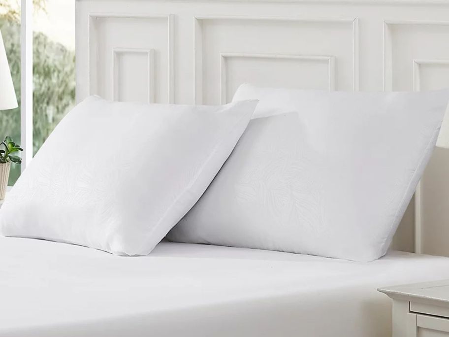 two Tommy Bahama Home Ultimate onlinefort Embossed Pillows on a bed