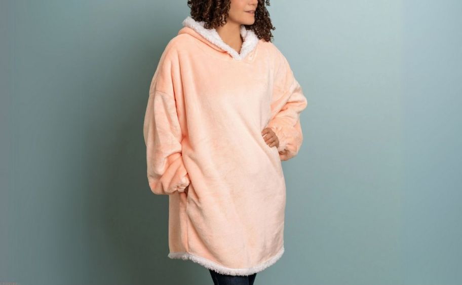 woman in a pink sherpa hoodie throw blanket